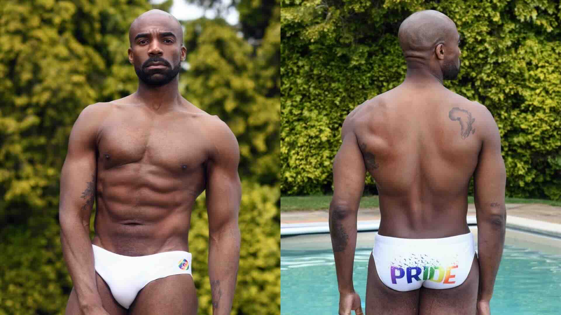 Ore Oduba poses in a pair of Pride-themed white Speedos
