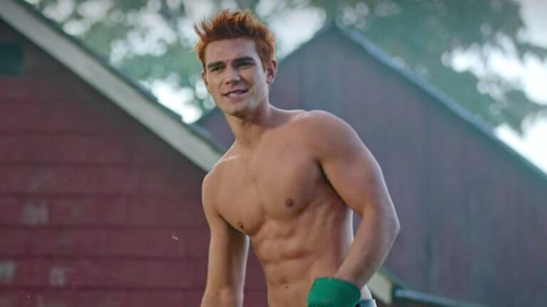 Kj Apa shirtless wearing gardening gloves