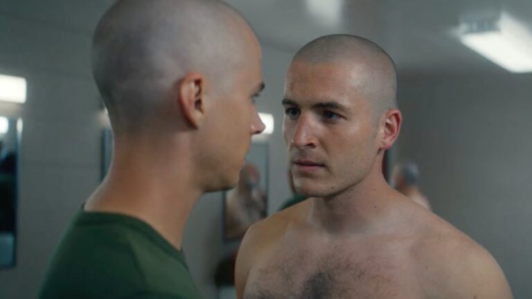 Miles Heizer (left) as Cameron and a topless Kieron Moore as Slovacek, in the boot camp changing rooms, talking (Image: Netflix)