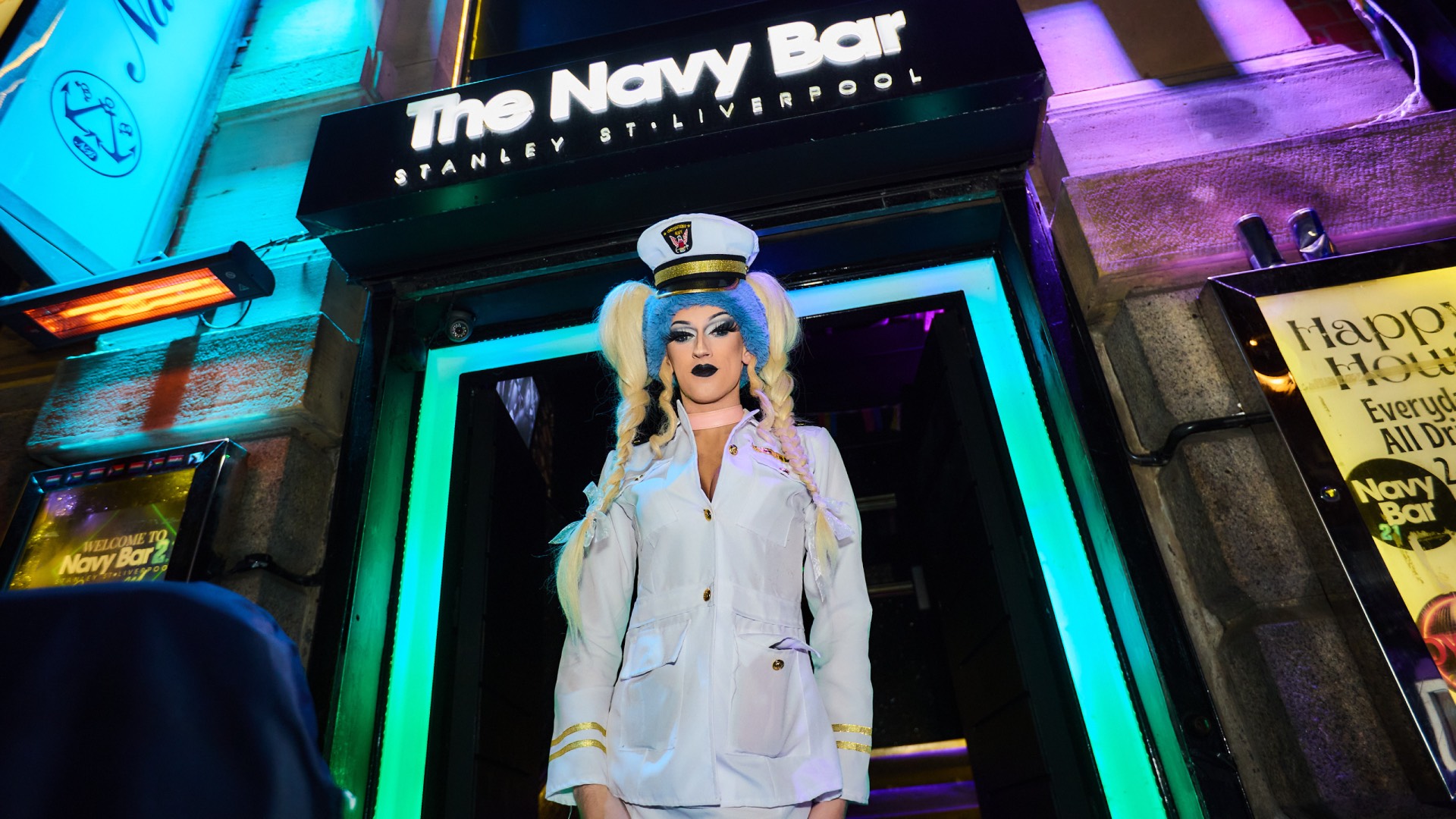 a drag queen standing outside Navy bar