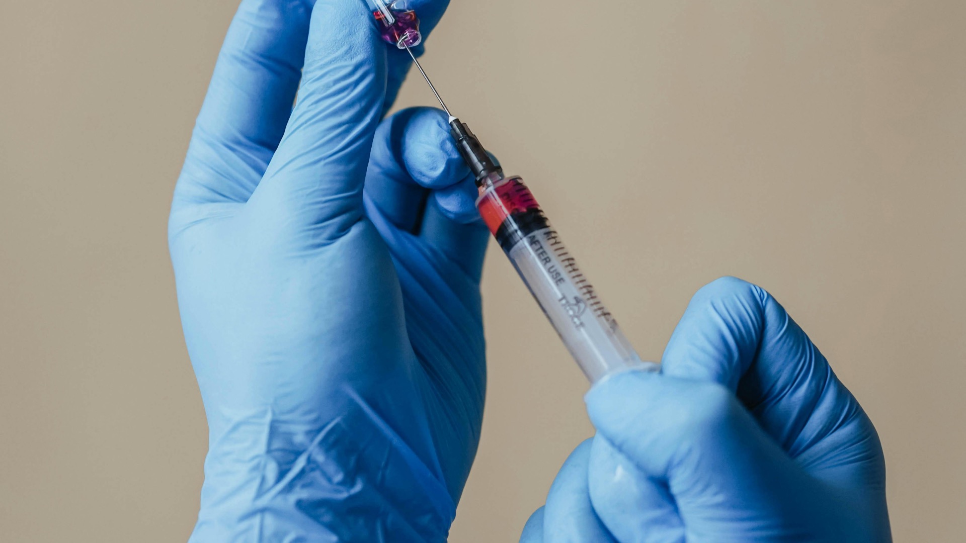 Blue gloves with a syringe