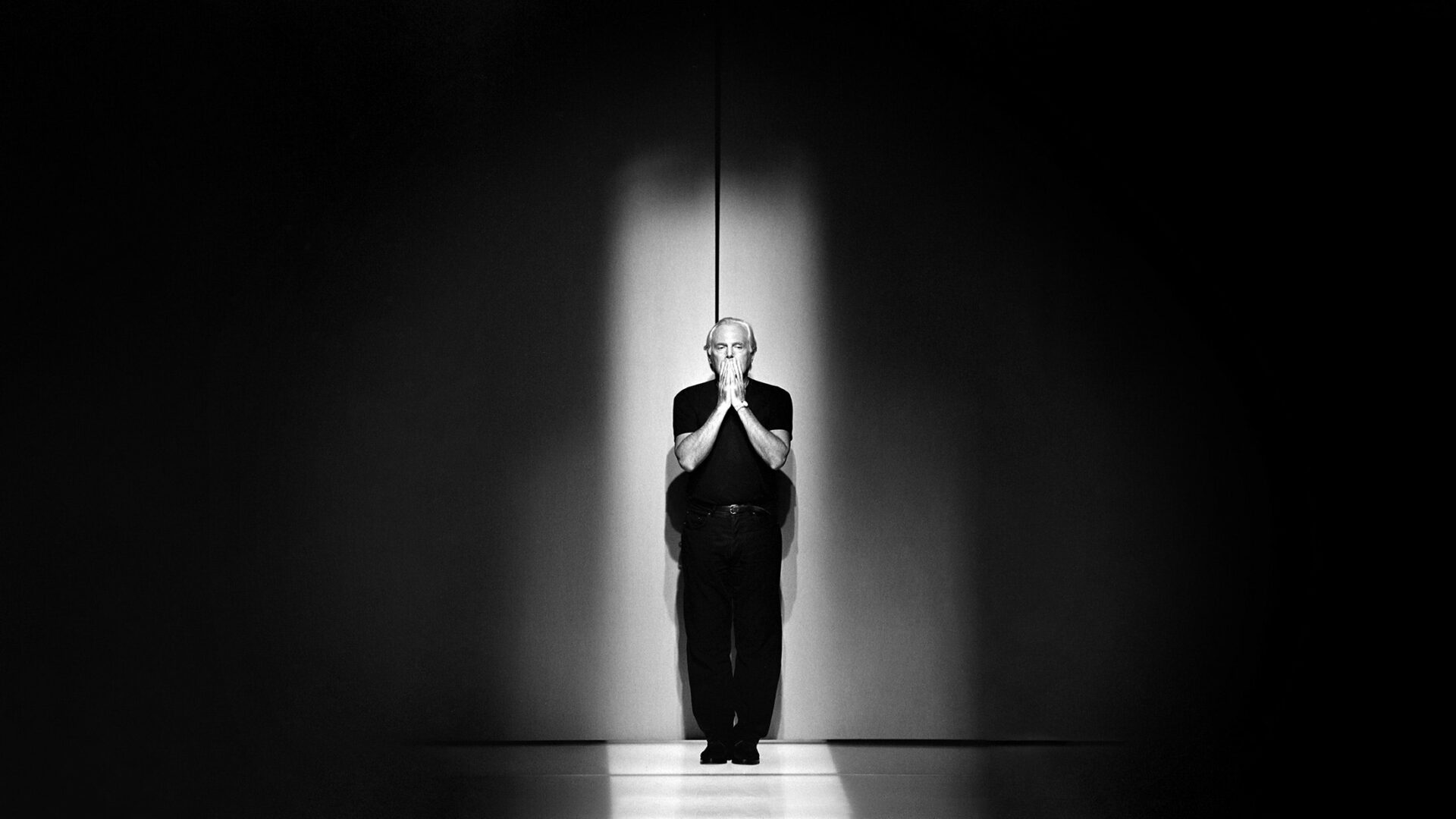 Black and white photo of Italian designer Giorgio Armani.