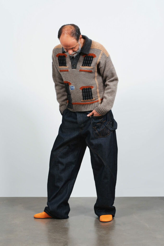 Director Luca Guadagnino models JW Anderson house knit for the brand's resort spring 2026 lookbook.