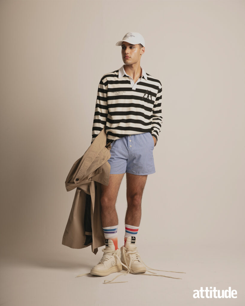 A model wears a rugby shirt and boxers in Attitude's menswear editorial. 