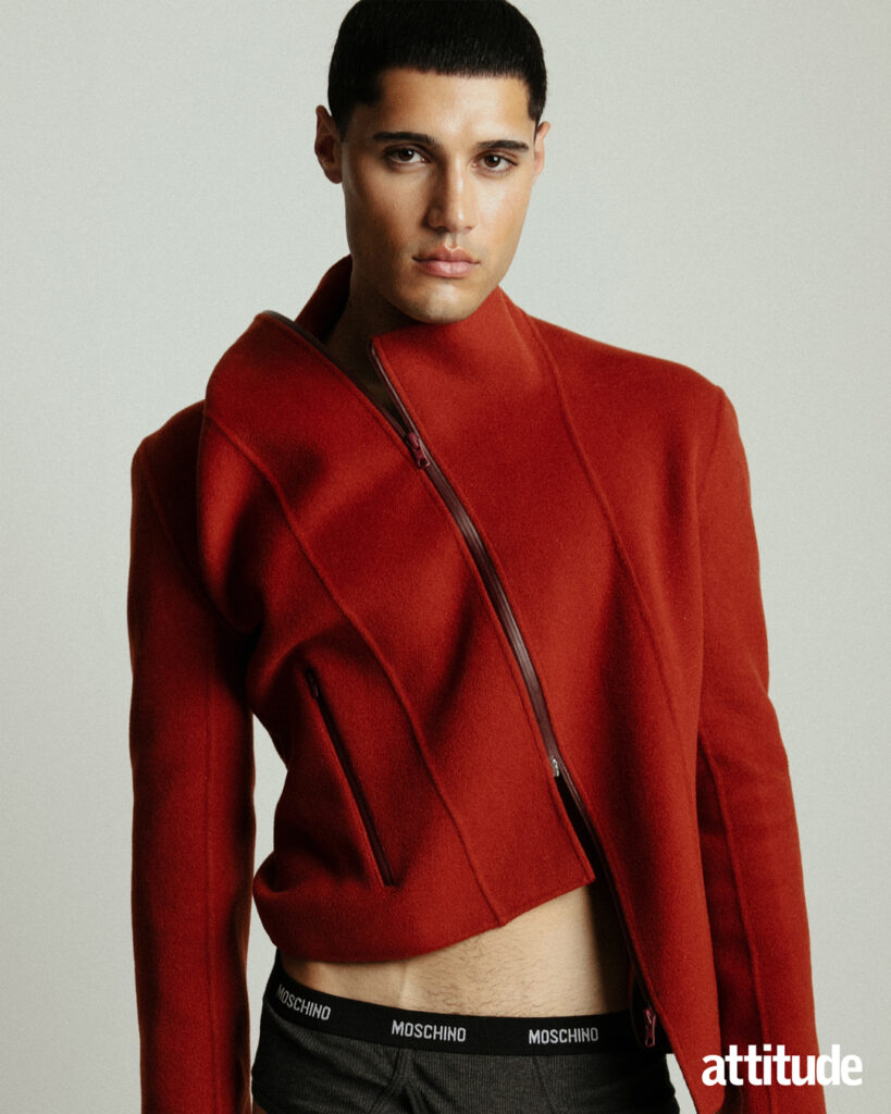 A model wears a red Jane Fu jacket in Attitude's fashion editorial. 
