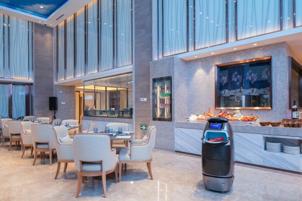 A catering robot moving a tray of food at	FlyZoo Hotel in Hangzhou, China