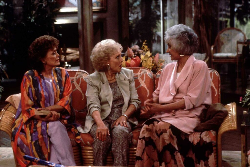 The Golden Girls cast chatting together on a sofa
