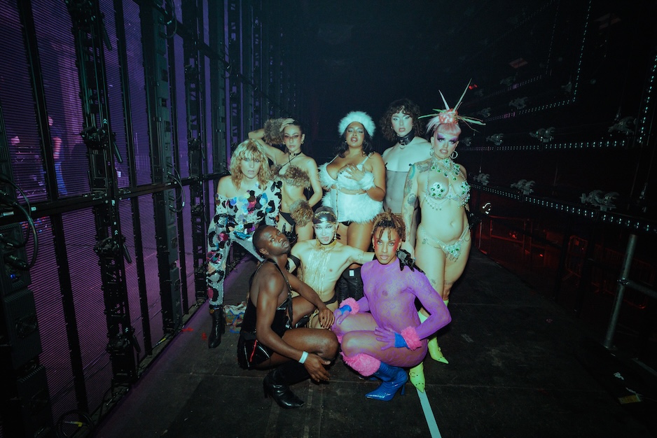 performers posing together backstage