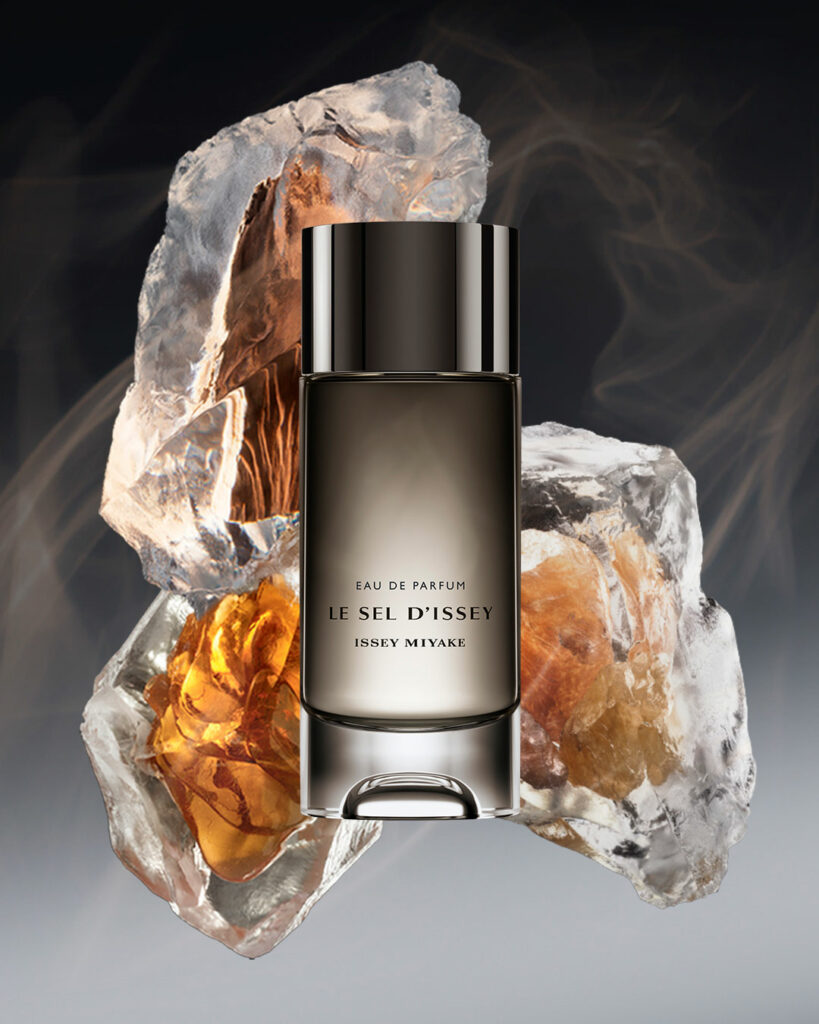 A bottle of Le Sel d’Issey perfume sitting in front of salt rocks