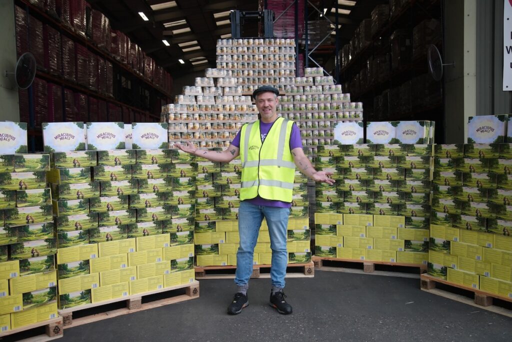 Will Young standing in front of canned dog food
