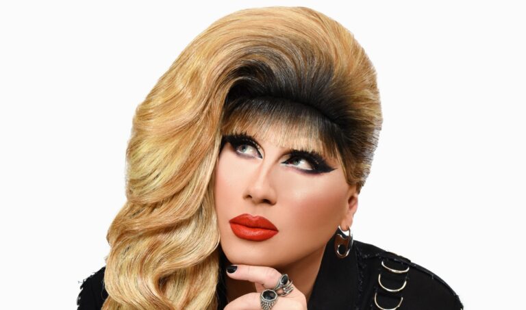 Jodie Harsh with her chin in her hand looking up