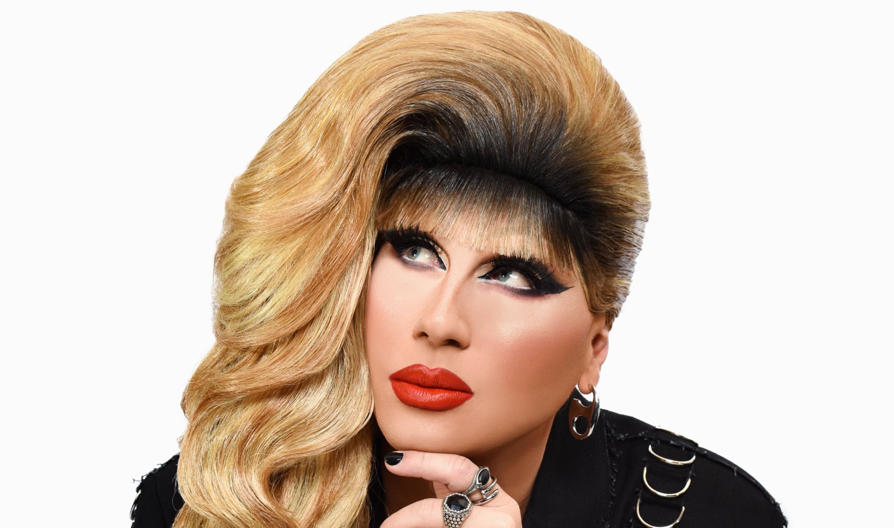 Jodie Harsh with her chin in her hand looking up
