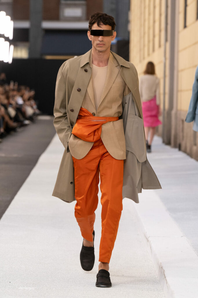 A model wears orange tailored trousers from the MM6 Spring/Summer 2026 show at Milan Fashion Week. 