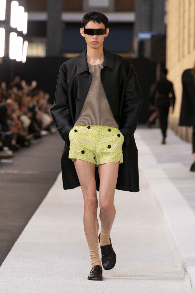 A model wears boxer shorts and a single-breasted coat at the MM6 Spring/Summer 2026 runway show at Milan Fashion Week. 