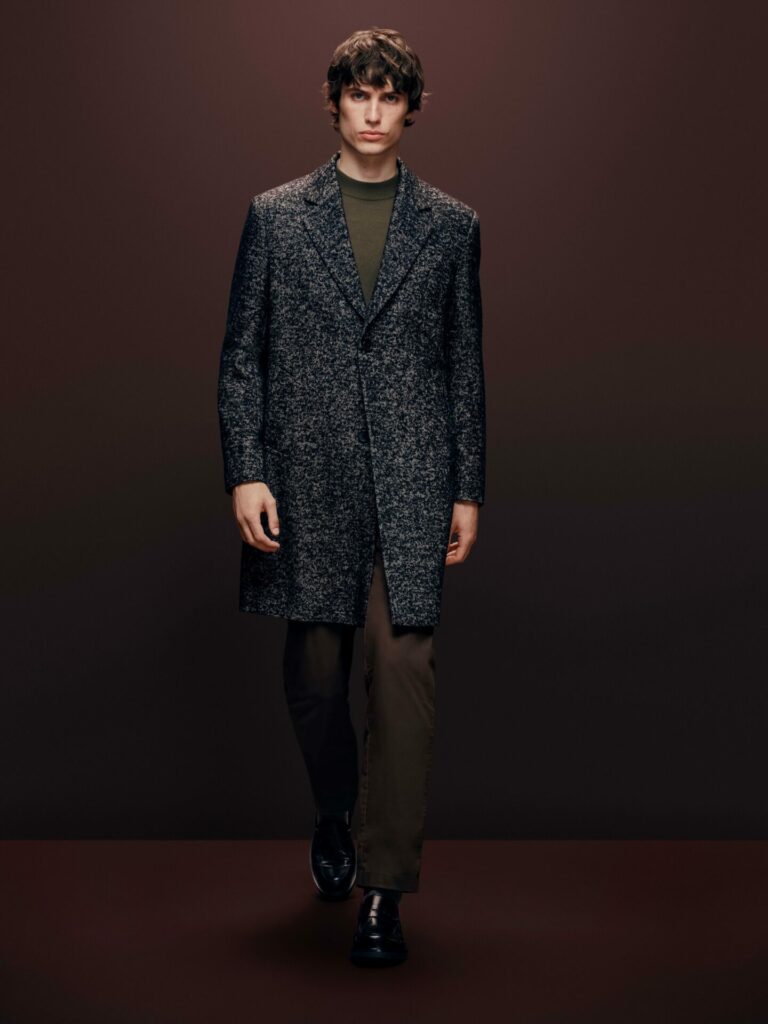 Male model walks a runway wearing a wood overcoat from the M&S Autograph Autumn/Winter 2025 collection.