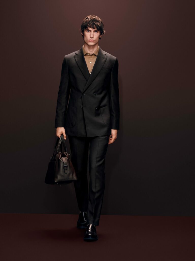 Male model walks a runway wearing a brown double-breasted suit from the M&S Autograph Autumn/Winter 2025 collection.