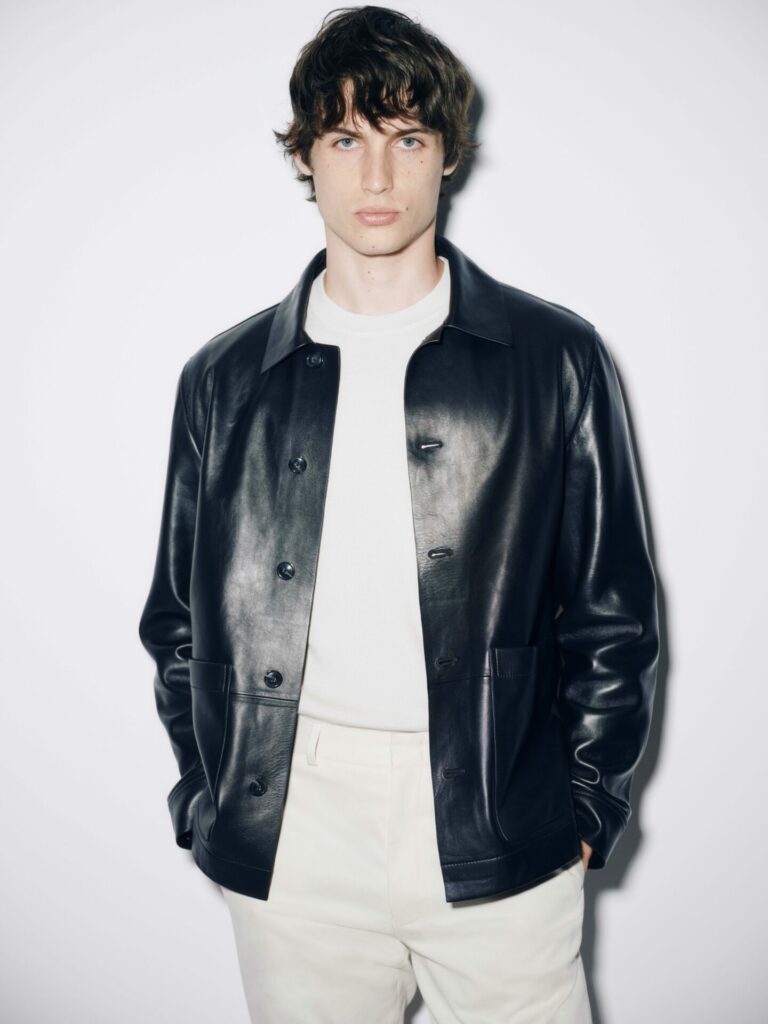 Male model wears leather work jacket over a white t-shirt for M&S Autograph Autumn/Winter 2025.