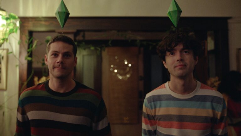 Dylan O'Brien and James Sweeney in Twinless - s still from the film, the guys in a dark room with in striped jumpers