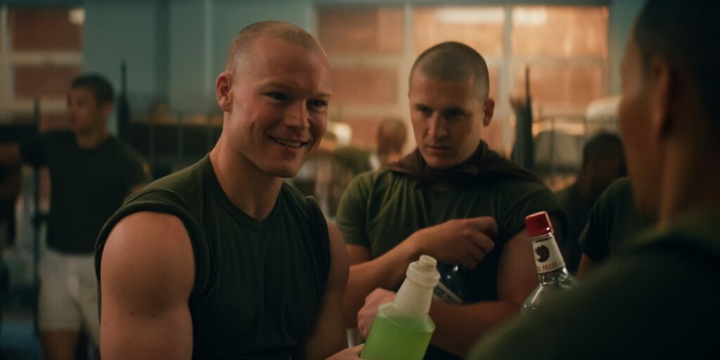 Angus O’Brien and Kieron Moore in Boots, in character, in green t-shirts in the bootcamp sleeping area (Image: Netflix)
