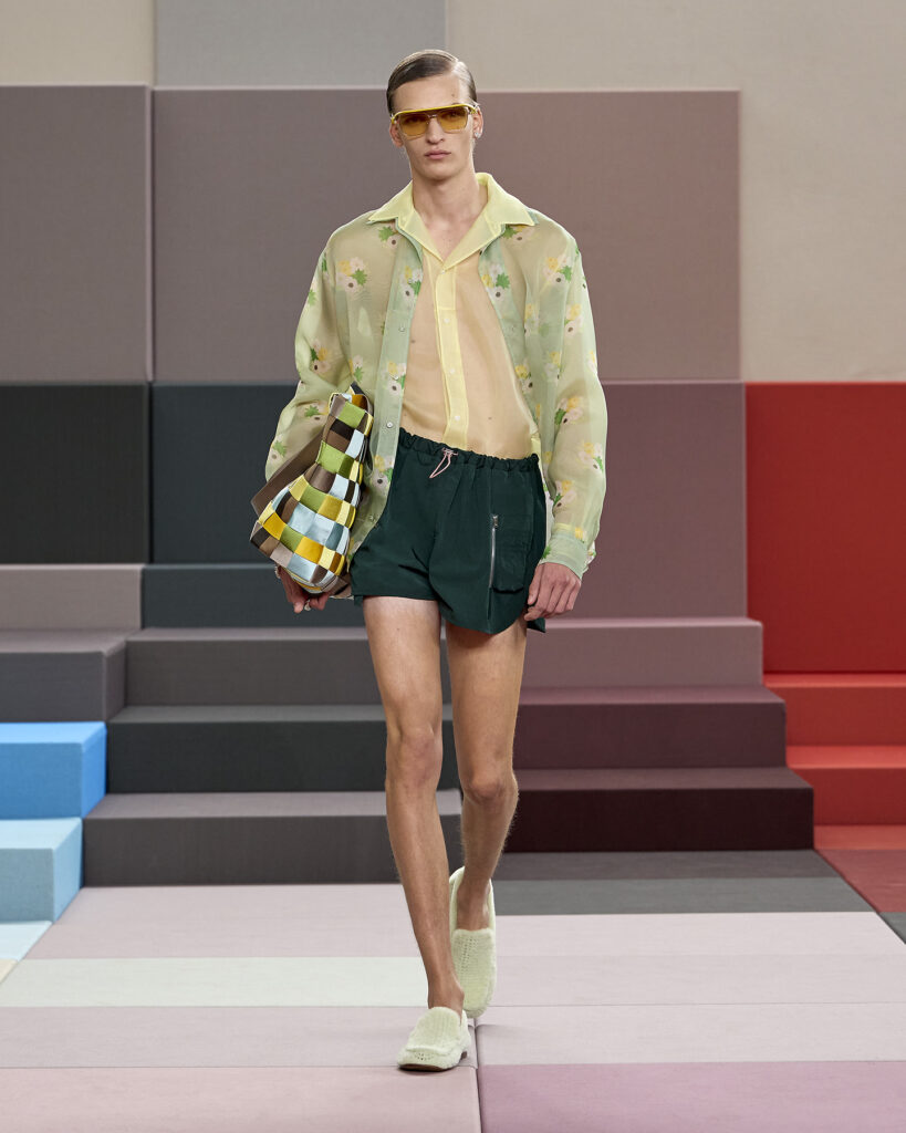A model wears a transparent shirt and cardigan at the Fendi Spring/Summer 2026 show in Milan.