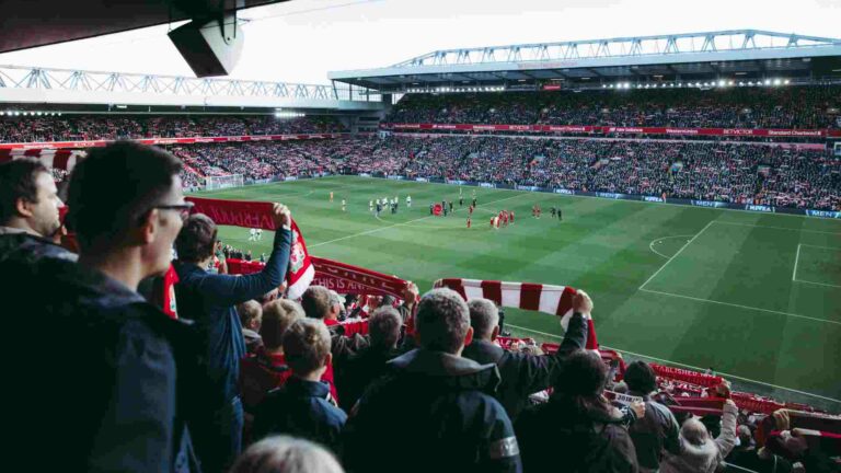 View of a football pitch from the stands filled with fans