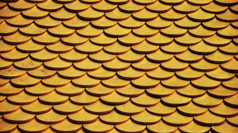 A row of golden coins stacked neatly together in a pattern