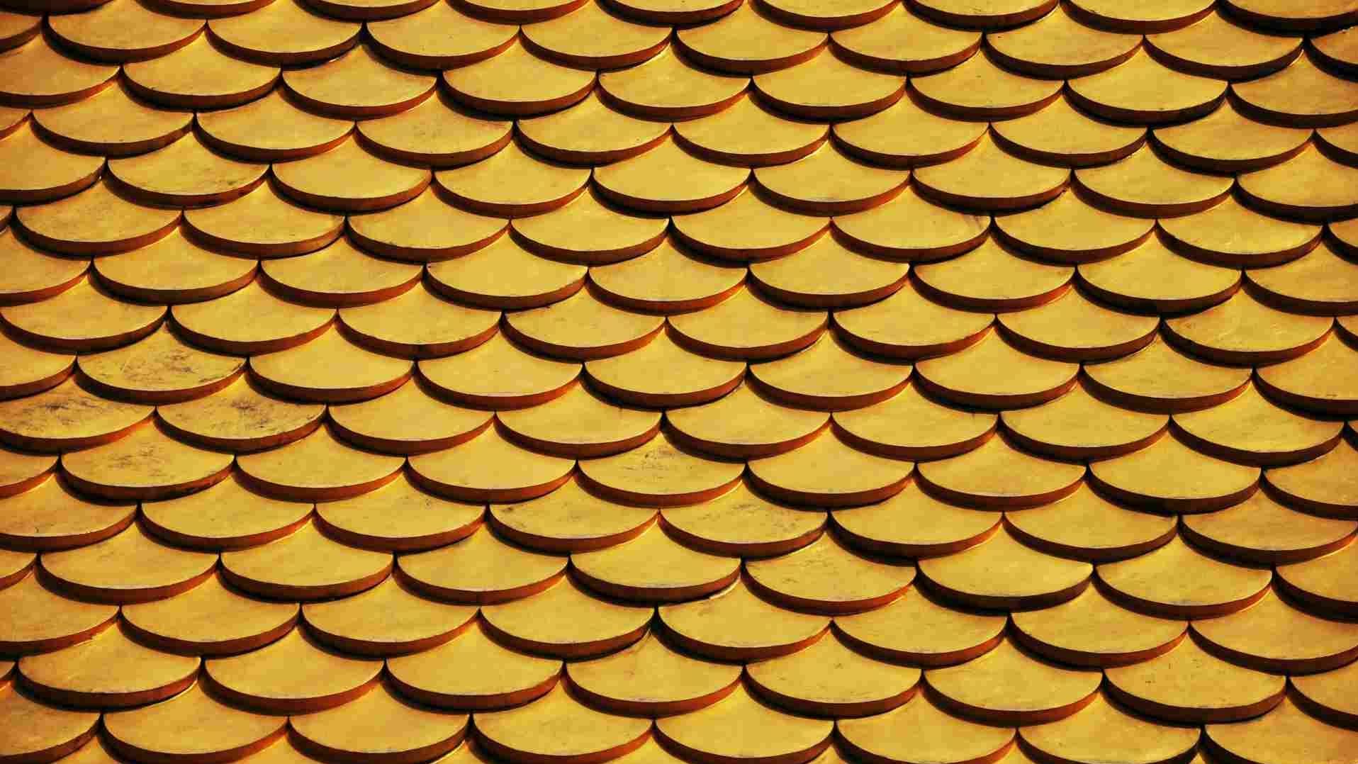 A row of golden coins stacked neatly together in a pattern