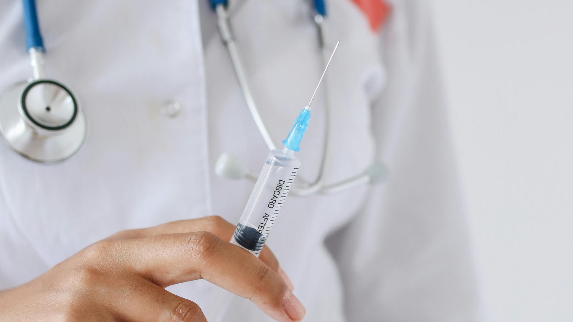 A nurse holding a syringe