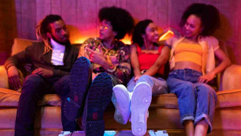 Group of people sitting on a sofa smiling