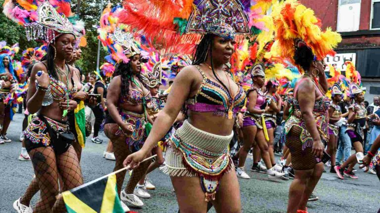 Women in colourful outfits in a street parade