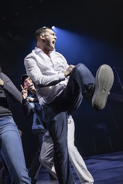 man on stage kicking