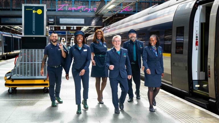 Group of Eurostar staff walking on the platform at a station