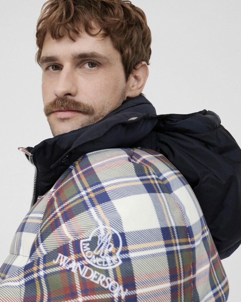 A lifestyle shot of a model wearing the new Moncler x JW Anderson collaboration puffer jacket