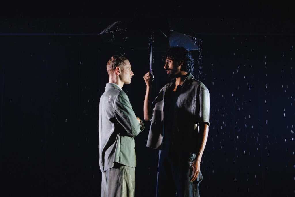 John McCrea as Prince George; Mihir Kumar as Dev Chatterjee under an umbrella in the rain