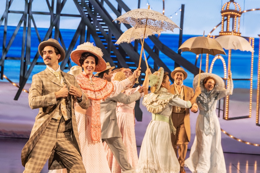 Cast of Ragtime holding umbrellas