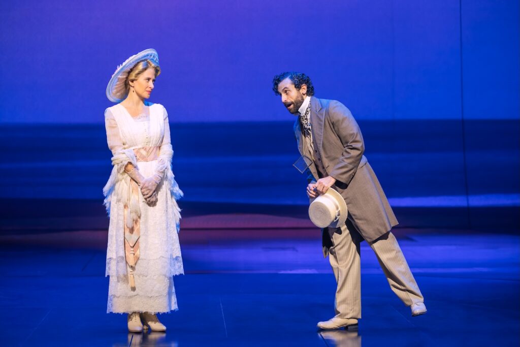 Cast of Ragtime man and woman leaning into each other on stage