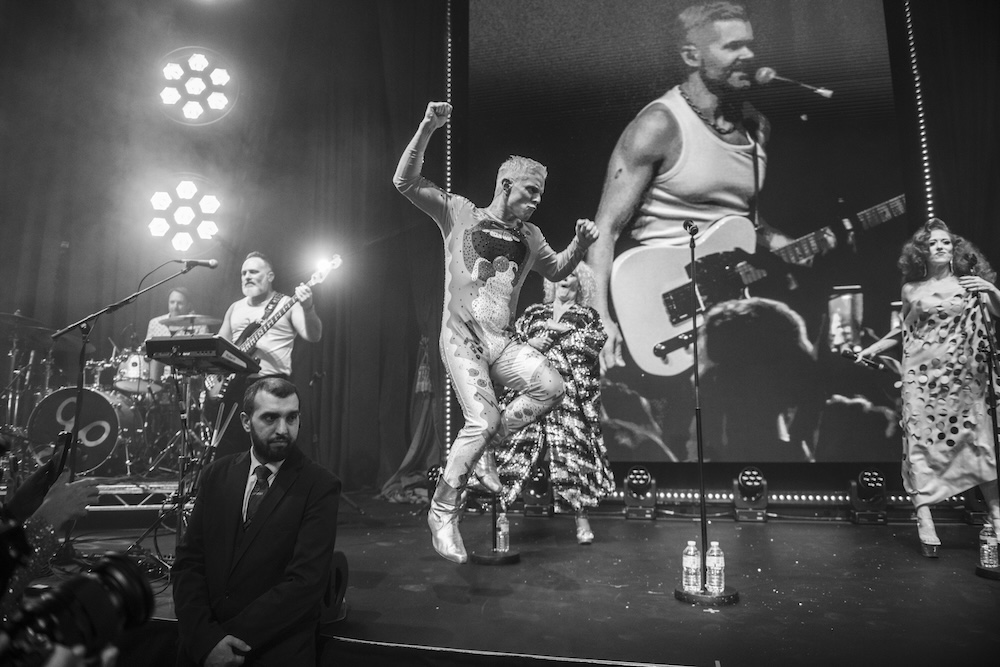 The Scissor Sisters performing on stage at the 2025 Attitude Awards with frontman Jake Shears jumping
