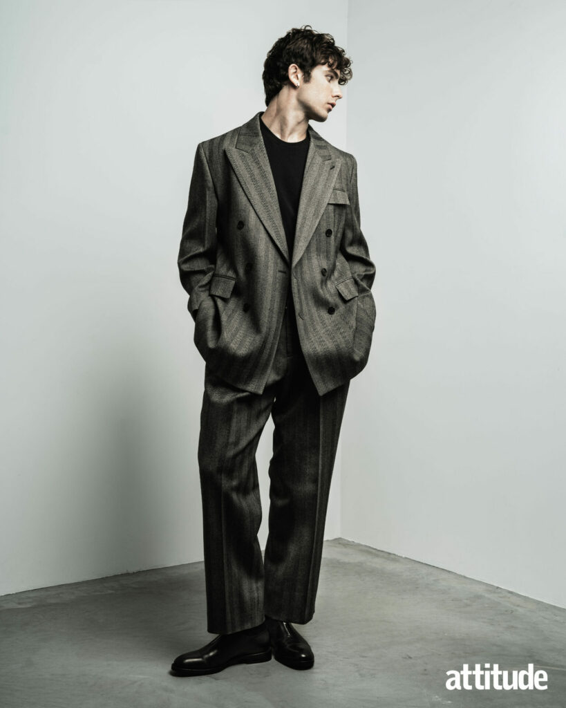 Model Edgar wears a grey double-breasted suit from Ferragamo with black Ferragamo shoes.