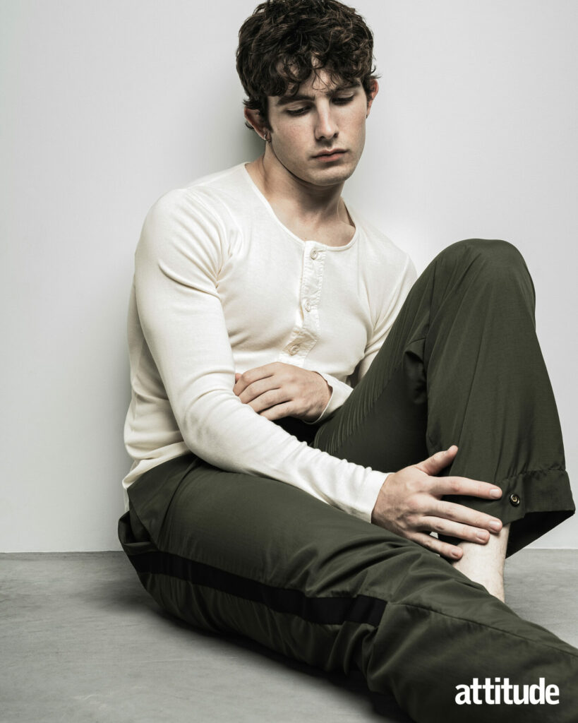 Model Edgar wears a cream henly from S.S. Daley and green trousers by DERRICK.