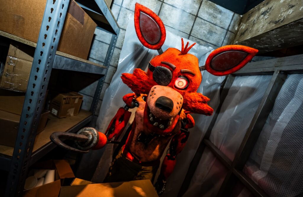 A Five Nights at Freddy's character at Halloween Horror Nights - a red mouse holding a knife in a storage room (Image: provided)