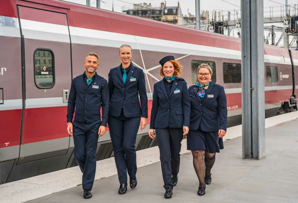Group of Eurostar staff walking beside a train