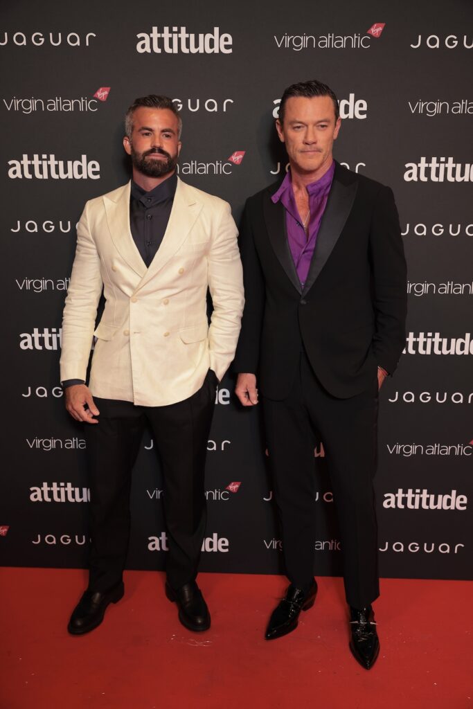 Luke Evans and his partner Fran Tomas in suits on the red carpet