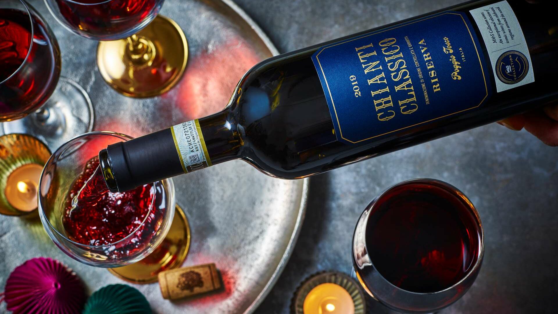 Aerial view of a bottle of red wine being poured into a glass