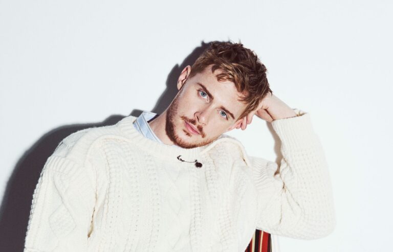 A head and shoulders shot of Matt in a white jumper against a white background