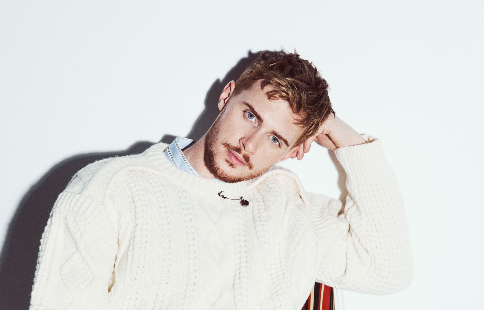 A head and shoulders shot of Matt in a white jumper against a white background