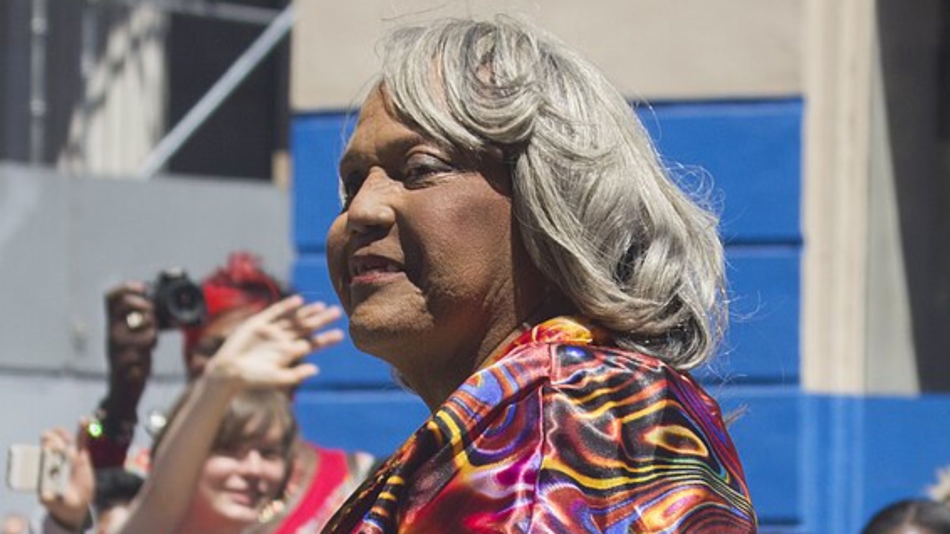 Miss Major at pride wearing a rainbow outfit