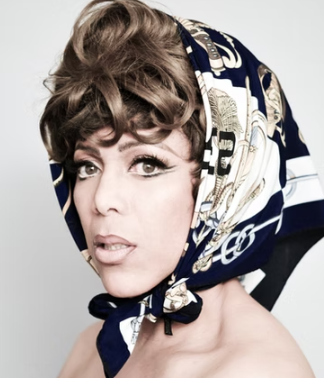 Mzz Kimberley head and shoulders shot, in patterned headscarf