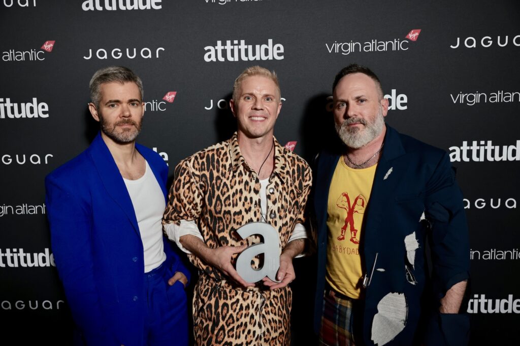 Del Marqis in blue, Jake Shears in leopard skin and Babydaddy in yellow t-shirt and black blazer backstage