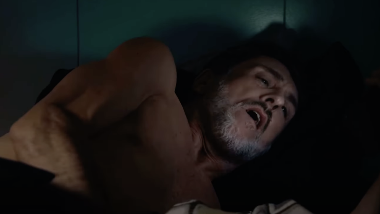 Man in bed watching porn