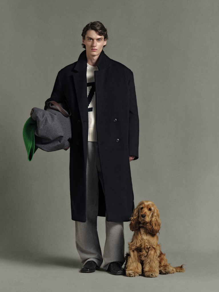 A model wears an overcoat from the Daniel Simmons Autumn/Winter 2025 collection.